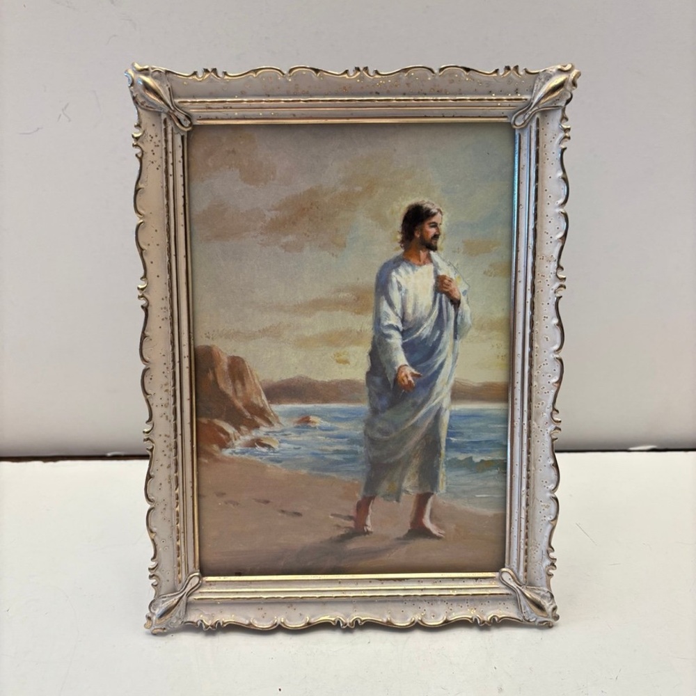 vintage-style framed artwork of Jesus Christ walking along a beach